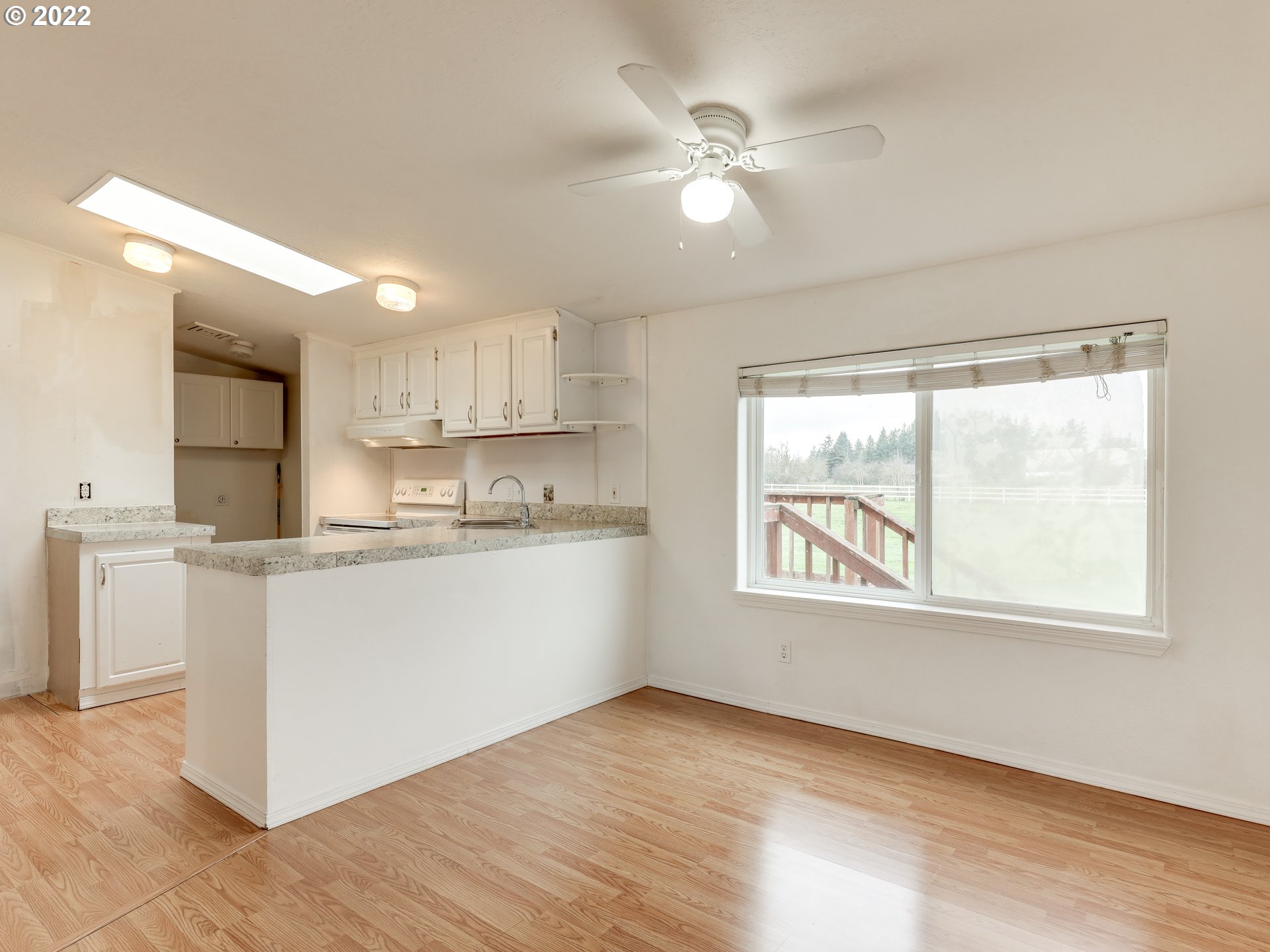 8489 South Gribble Road Canby, OR 97013 - Photo 11 of 32 a kitchen with a window a sink and a refrigerator