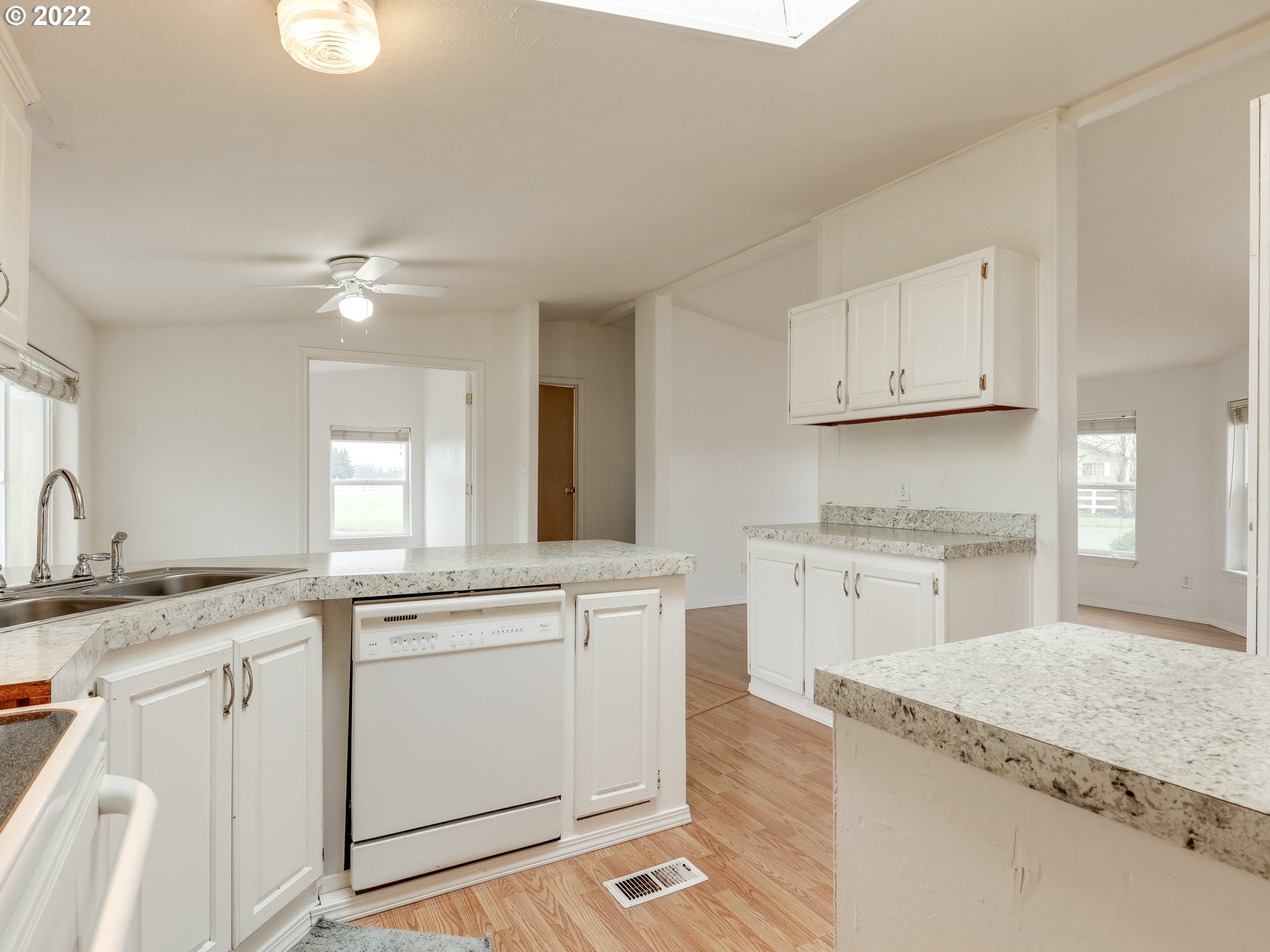 8489 South Gribble Road Canby, OR 97013 - Photo 14 of 32 a kitchen with granite countertop white cabinets white appliances with a sink and dishwasher