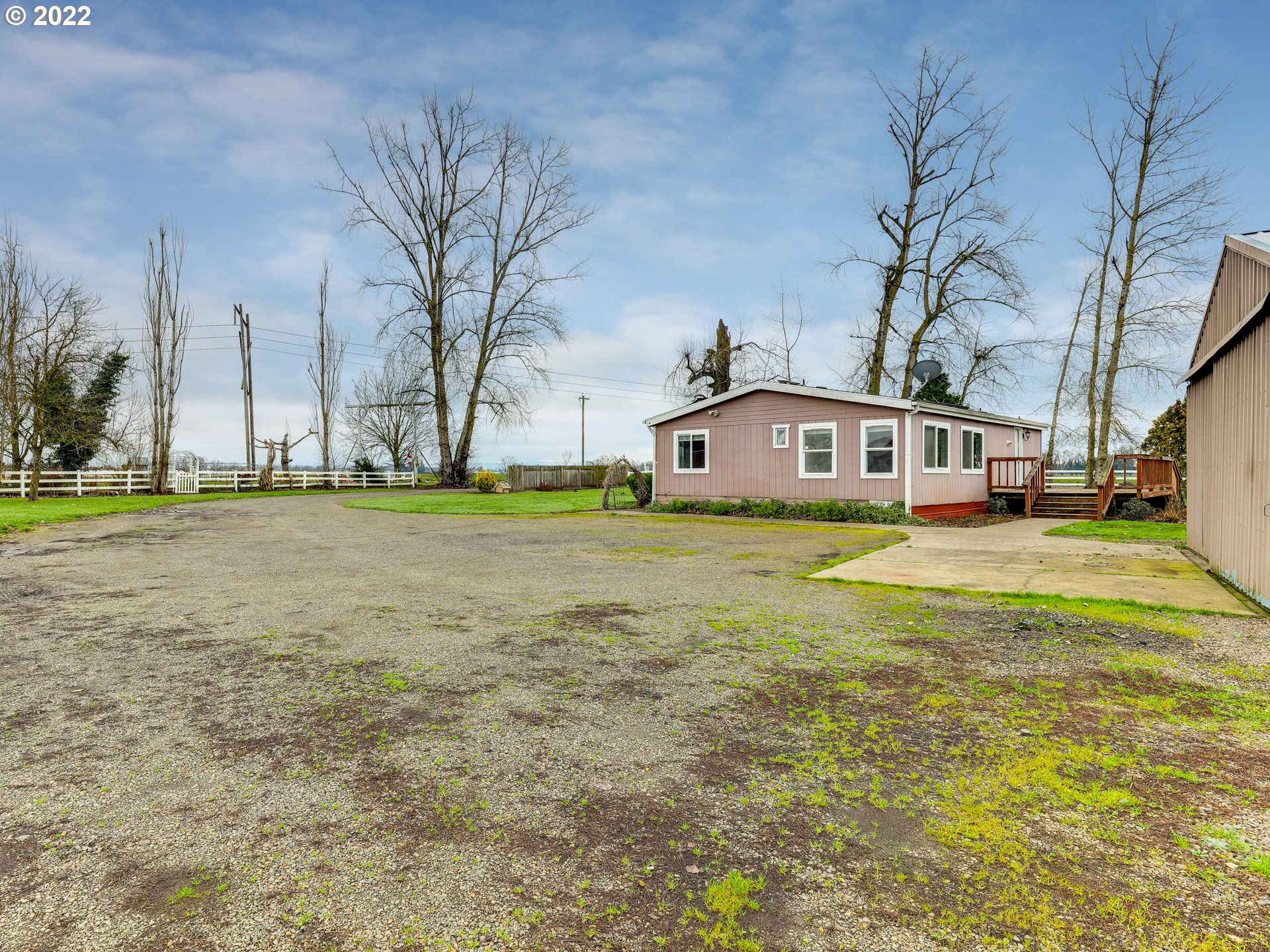 8489 South Gribble Road Canby, OR 97013 - Photo 27 of 32 a front view of residential houses with yard and trees