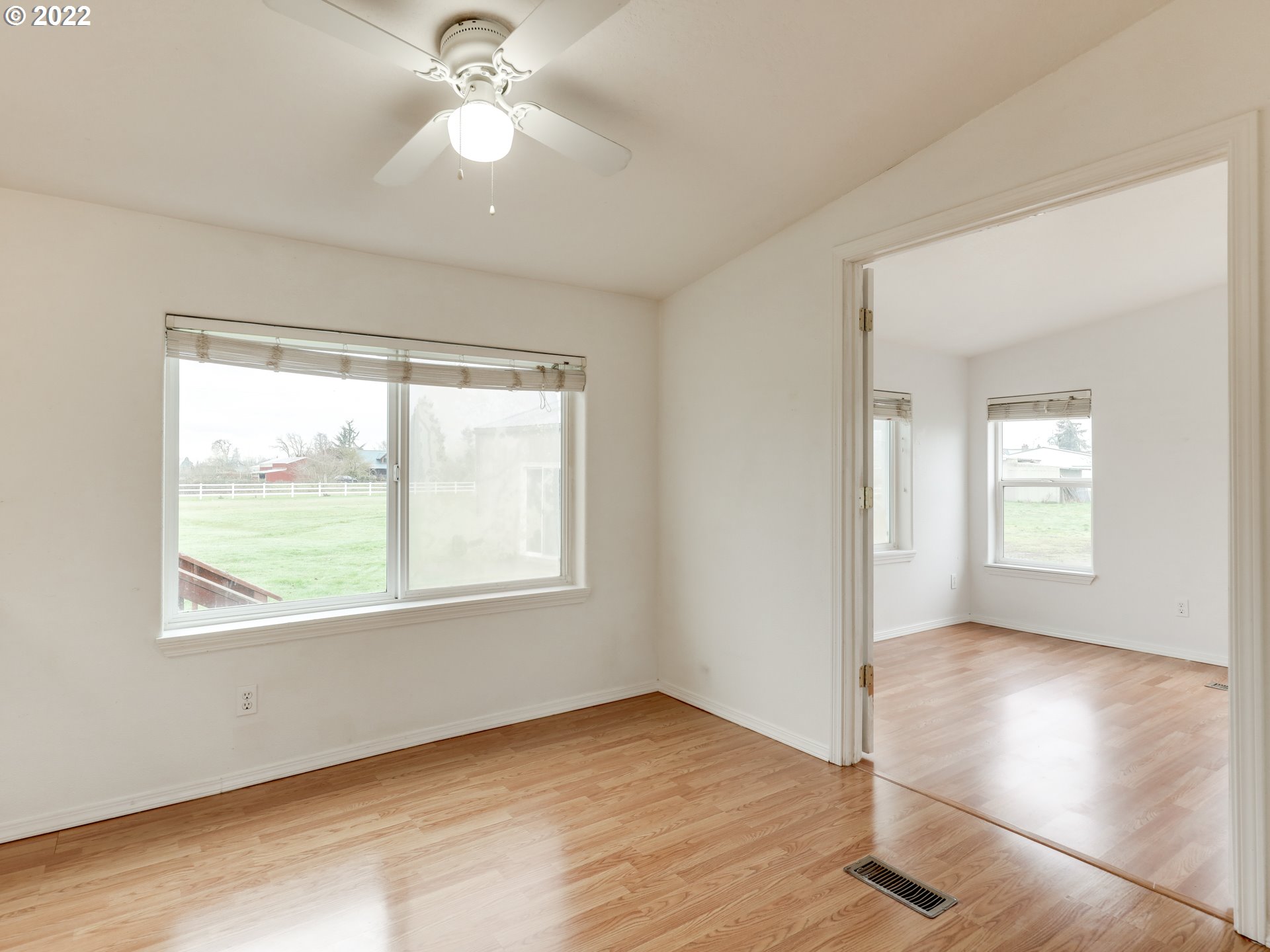 8489 South Gribble Road Canby, OR 97013 - Photo 10 of 32 a view of an empty room with wooden floor and a window