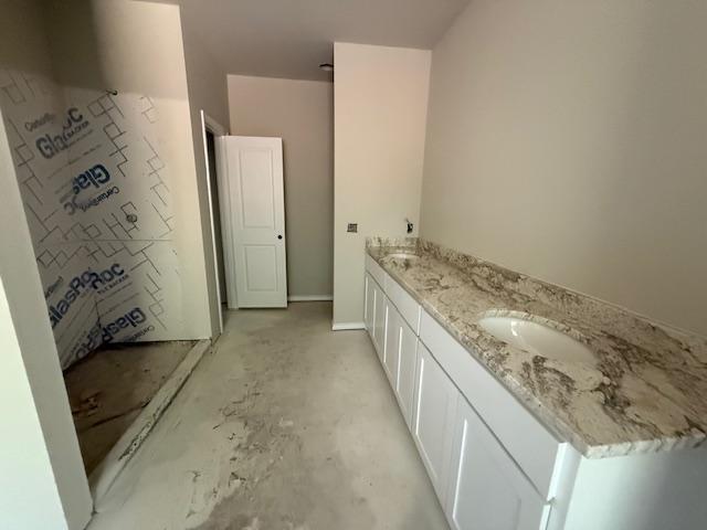 1203 Anthony Street Gainesville, TX 76240 - Photo 13 of 24 a bathroom with a granite countertop sink a mirror and shower