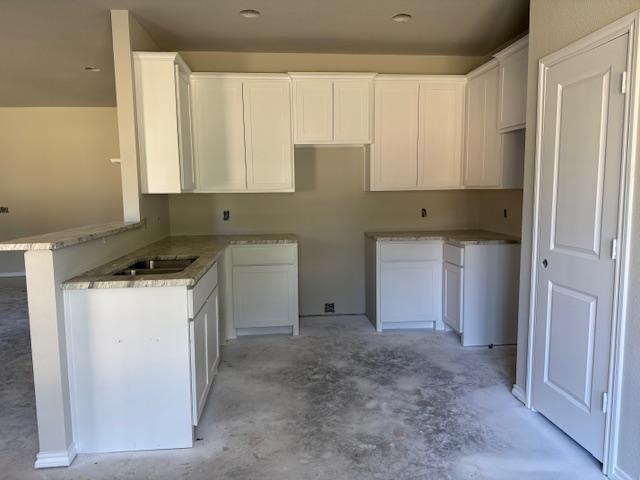 1203 Anthony Street Gainesville, TX 76240 - Photo 3 of 24 a kitchen with a refrigerator a sink and cabinets