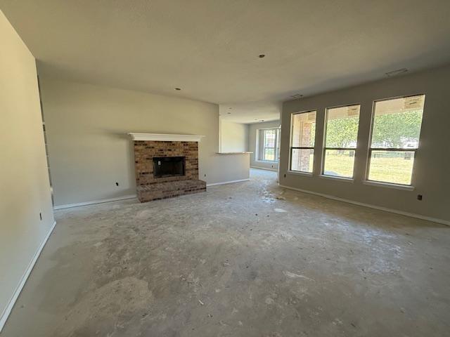1203 Anthony Street Gainesville, TX 76240 - Photo 7 of 24 an empty room with a fireplace and windows