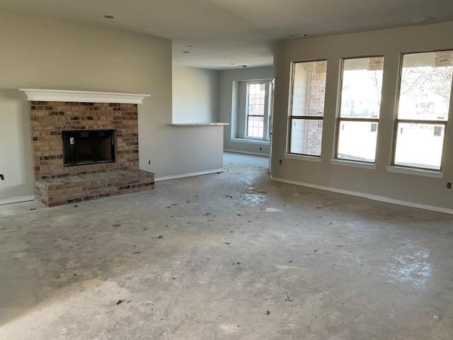1203 Anthony Street Gainesville, TX 76240 - Photo 8 of 24 an empty room with windows and fireplace