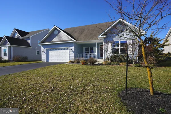an empty room with windows and chandelier fan