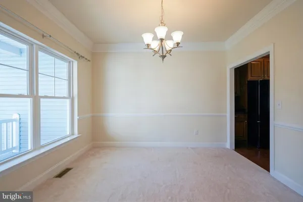 a view of empty room with fireplace and wooden floor