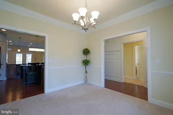 a view of a big room with wooden floor and windows