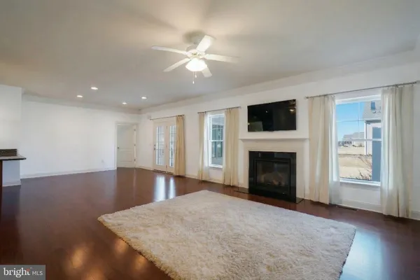 a kitchen with stainless steel appliances a stove a sink a microwave a refrigerator and chairs