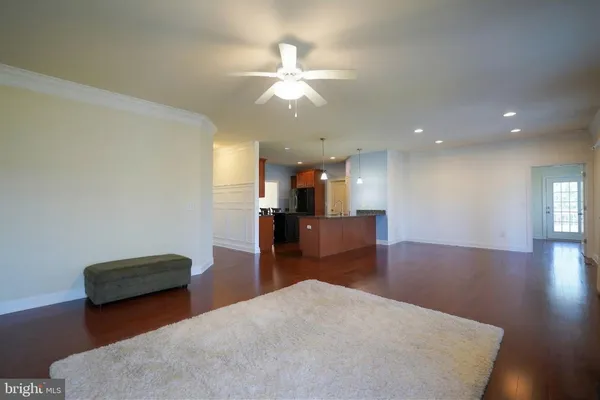 a kitchen with stainless steel appliances granite countertop wooden floors and wooden cabinets