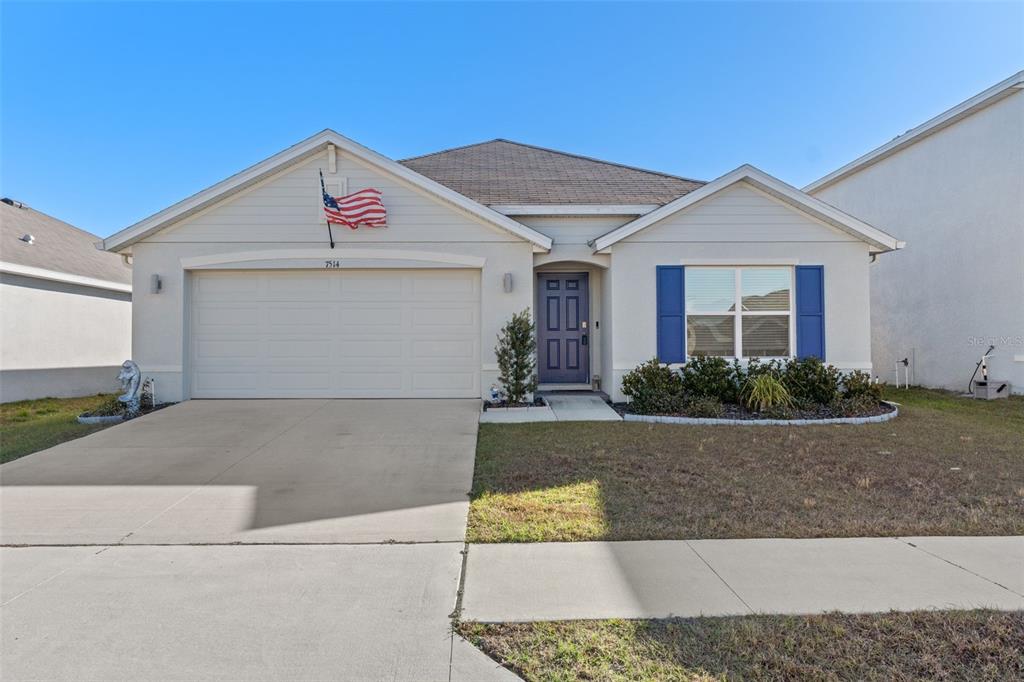 7514 Gardner Street Brooksville, FL 34613 - Photo 1 of 49 a front view of a house with yard