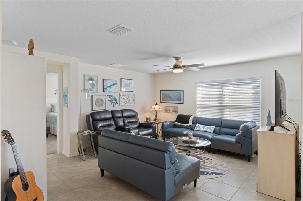 7514 Gardner Street Brooksville, FL 34613 - Photo 18 of 49 a living room with furniture and a flat screen tv