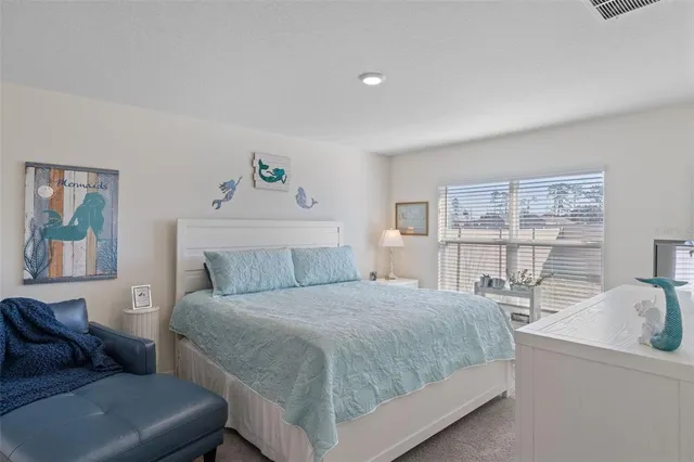 a bedroom with a bed and a couch