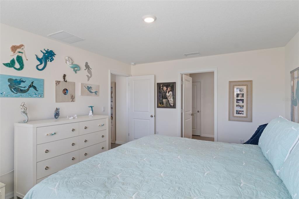 7514 Gardner Street Brooksville, FL 34613 - Photo 20 of 49 a bedroom with a bed and a dresser