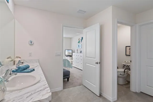 a bathroom with a granite countertop sink and shower