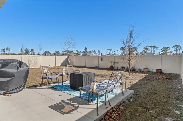 a view of a terrace with chairs and a stove