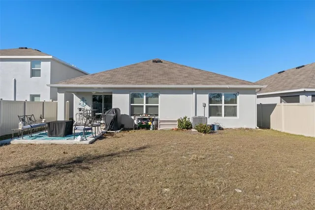 a view of a house with backyard sitting area and porch