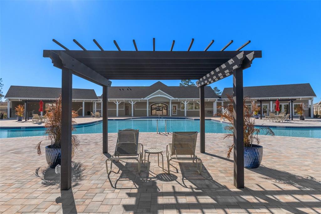 7514 Gardner Street Brooksville, FL 34613 - Photo 48 of 49 a patio with table and chairs and potted plants