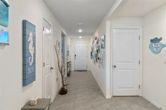 a view of a hallway with entryway and stairs