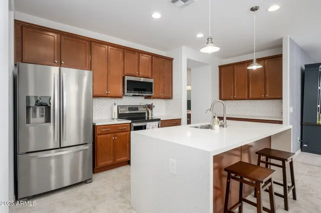 a kitchen with stainless steel appliances granite countertop a sink and a microwave