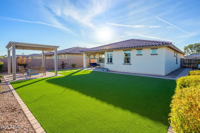 a view of green field with house in the background