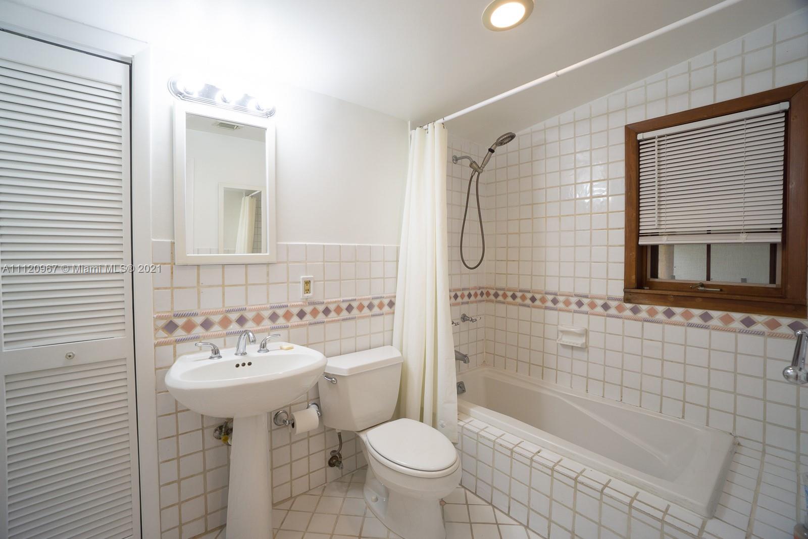 4423 Anderson Road Coral Gables, FL 33146 - Photo 14 of 18 a bathroom with a sink toilet mirror and shower