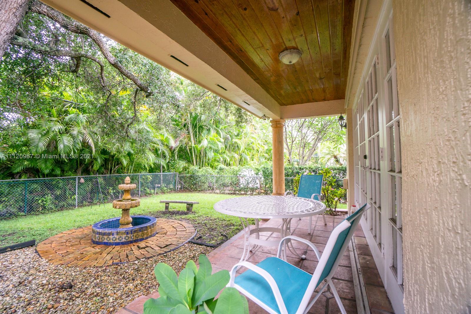 4423 Anderson Road Coral Gables, FL 33146 - Photo 16 of 18 a view of yard from deck with patio