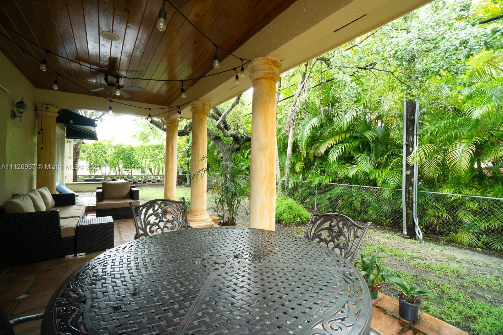 4423 Anderson Road Coral Gables, FL 33146 - Photo 17 of 18 a balcony with furniture and a garden