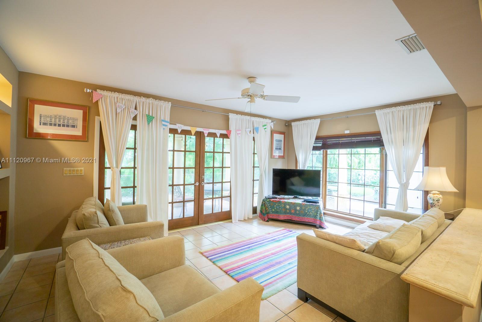 4423 Anderson Road Coral Gables, FL 33146 - Photo 4 of 18 a living room with furniture and a flat screen tv