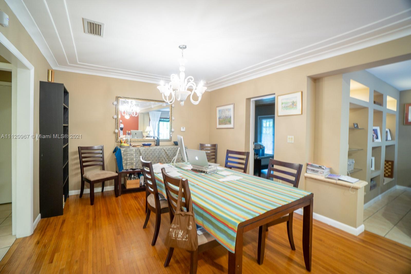 4423 Anderson Road Coral Gables, FL 33146 - Photo 5 of 18 a view of a dining room with furniture and wooden floor