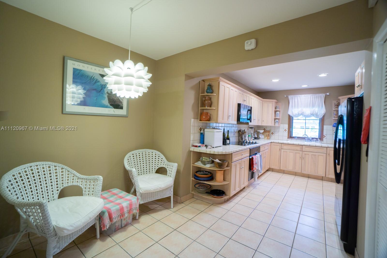 4423 Anderson Road Coral Gables, FL 33146 - Photo 7 of 18 a kitchen with a cabinets and chandelier