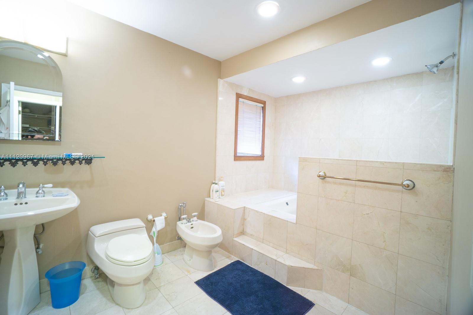 4423 Anderson Road Coral Gables, FL 33146 - Photo 9 of 18 a bathroom with a sink a toilet and shower