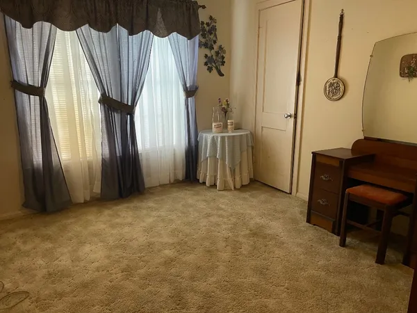 a view of a room with window and furniture