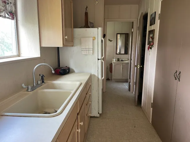 a kitchen with a sink and a refrigerator