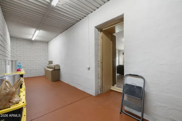 a bedroom with a bed and dresser with mirror