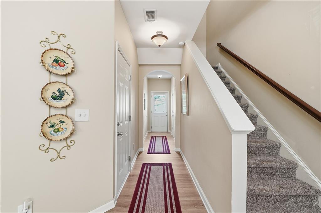 608 Myers Gate Road Ball Ground, GA 30107 - Photo 13 of 31 a view of a hallway with wooden floor