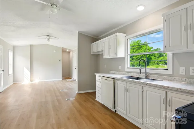 a kitchen with a sink cabinets and window