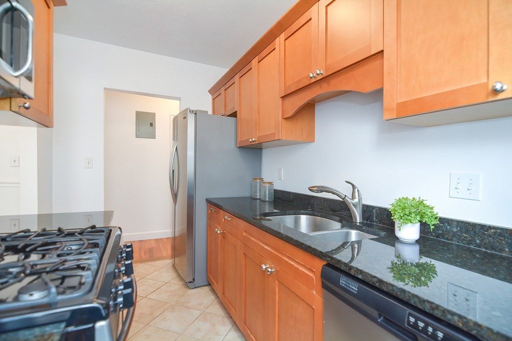 40 Browne Street, Unit 5 Brookline, MA 02446 - Photo 20 of 39 a kitchen with granite countertop a sink and a stove