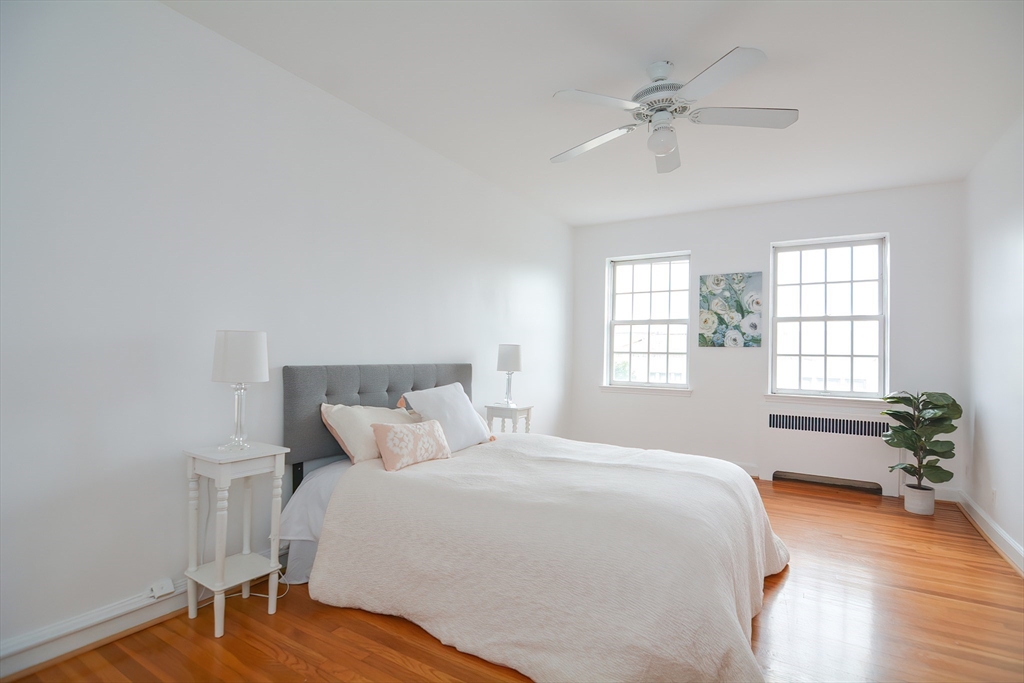 40 Browne Street, Unit 5 Brookline, MA 02446 - Photo 23 of 39 a bedroom with a bed and a potted plant