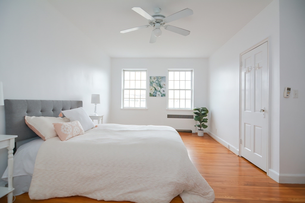 40 Browne Street, Unit 5 Brookline, MA 02446 - Photo 26 of 39 a bedroom with a large bed and a chandelier fan