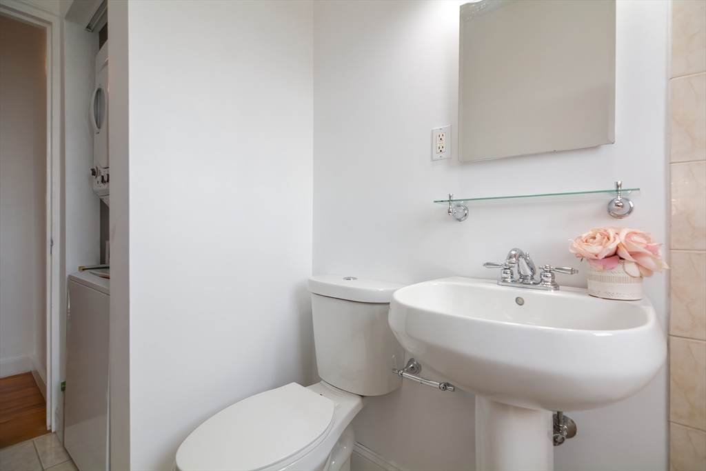 40 Browne Street, Unit 5 Brookline, MA 02446 - Photo 36 of 39 a bathroom with a sink a toilet and mirror