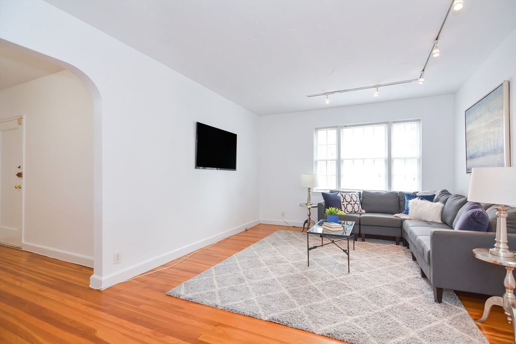 40 Browne Street, Unit 5 Brookline, MA 02446 - Photo 6 of 39 a living room with furniture and a flat screen tv