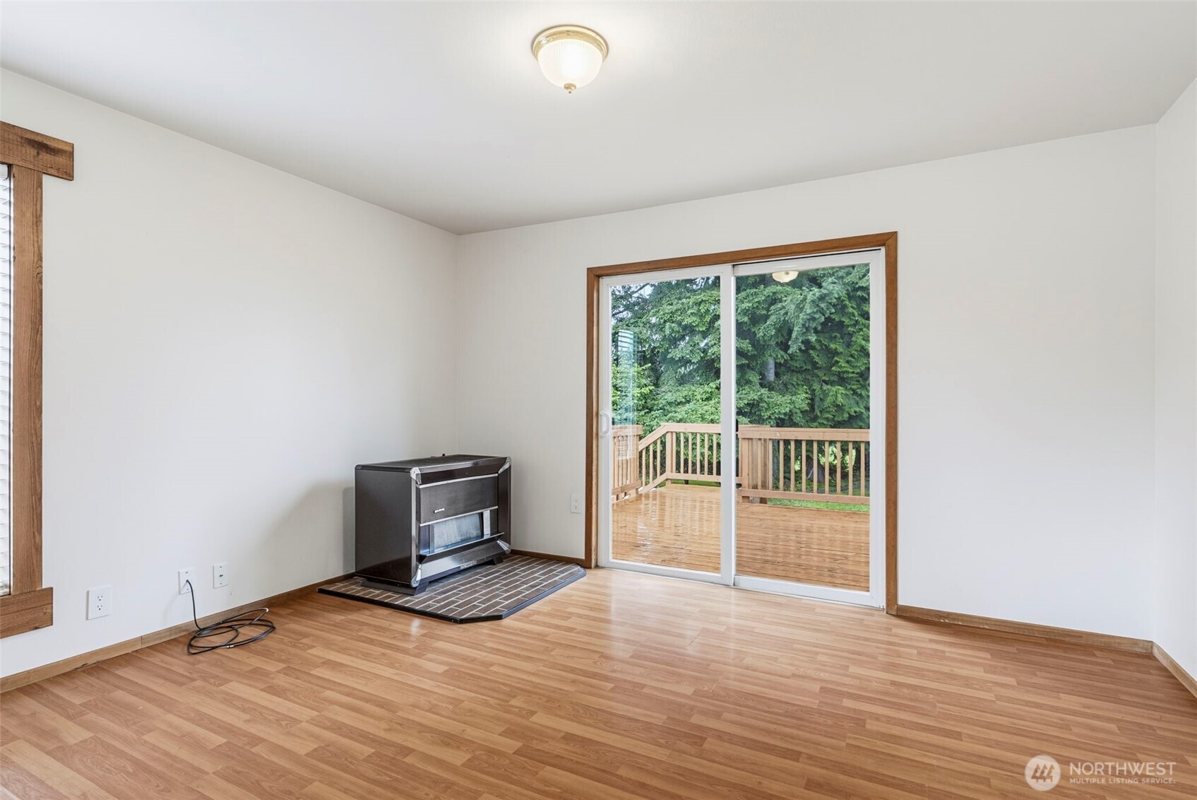 175 Jacobson Road Cathlamet, WA 98612 - Photo 18 of 32 a view of an empty room with wooden floor and a window