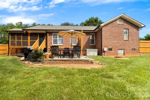 a view of a house with pool and sitting area