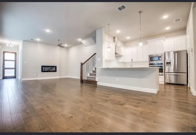 a view of kitchen with cabinets and wooden floor