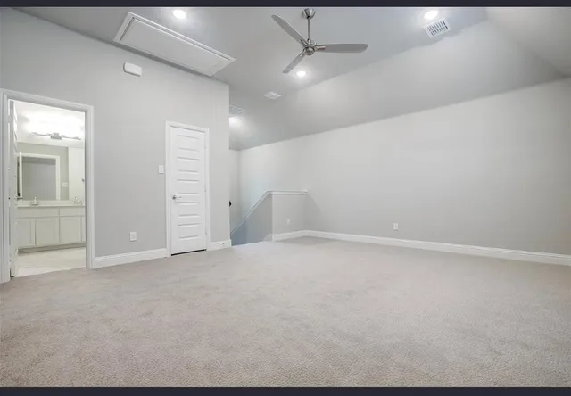 an empty room with closet and windows