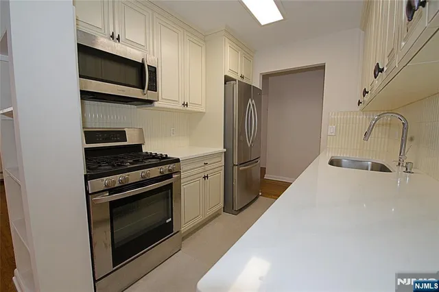a kitchen with a refrigerator stove and microwave