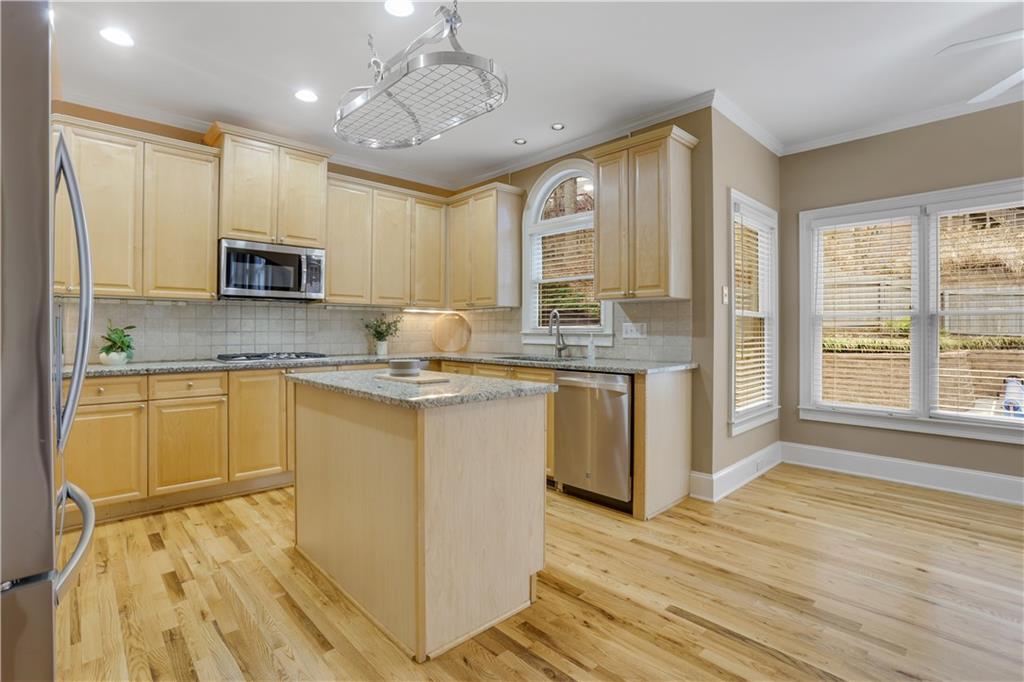 803 Rocky Ridge Court Canton, GA 30114 - Photo 17 of 80 a kitchen with granite countertop a stove a sink and a refrigerator