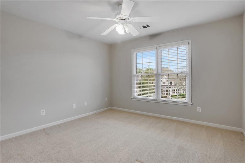 803 Rocky Ridge Court Canton, GA 30114 - Photo 46 of 80 an empty room with a window and a fan