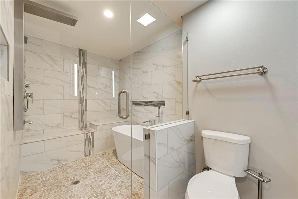 10216 Carry Back Circle Dallas, TX 75229 - Photo 20 of 28 a white toilet sitting next to a bathroom sink and a shower