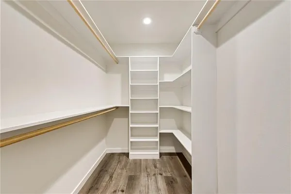 a view of walk in closet with empty racks